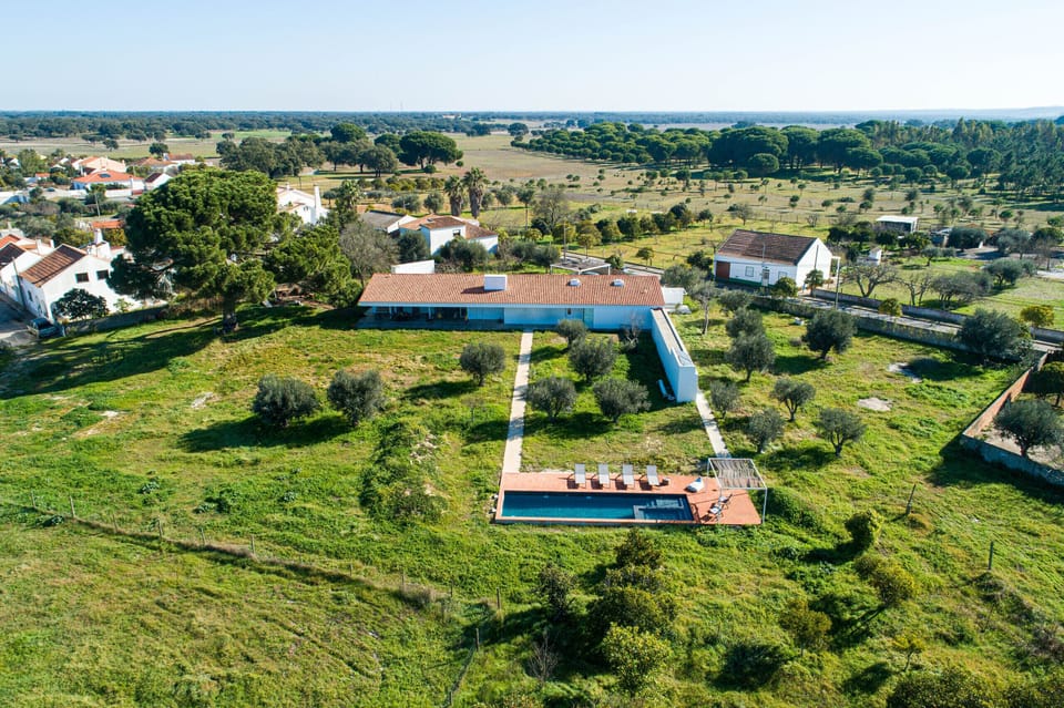 Aerial view of blue-trimmed main house with pool and terrace — Villa do Pinheiro, luxury holiday villa in Grândola
