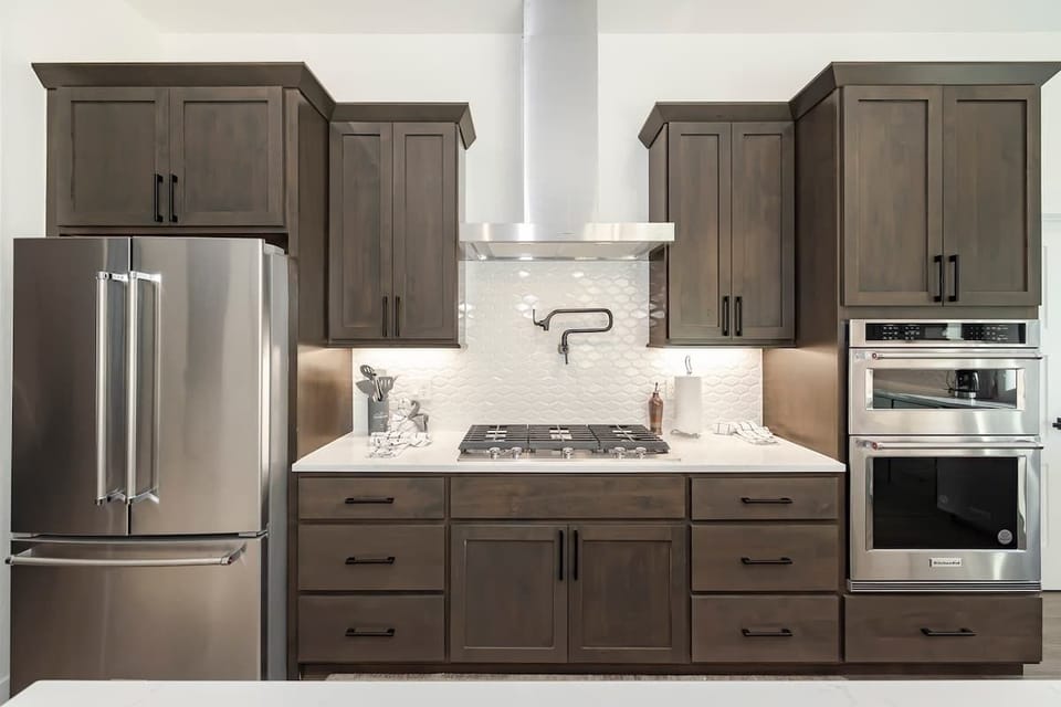 - Fully stocked kitchen with gas cooktop, double oven, and stainless steel fridge
- Under cabinet lighting and subway tile backsplash elevate every culinary moment
- Built for cooking, gathering, and great memories