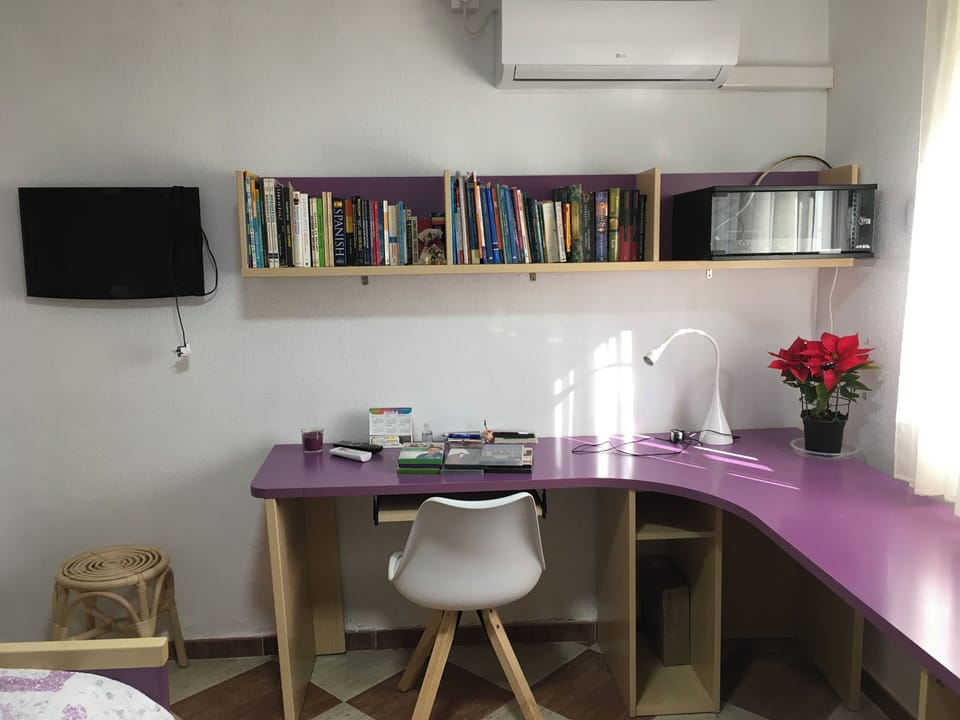 Bedroom 1 desk with books, CD & DVD player