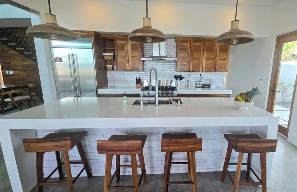 One of two new kitchennew with microwave, commercial Range, and dishwasher