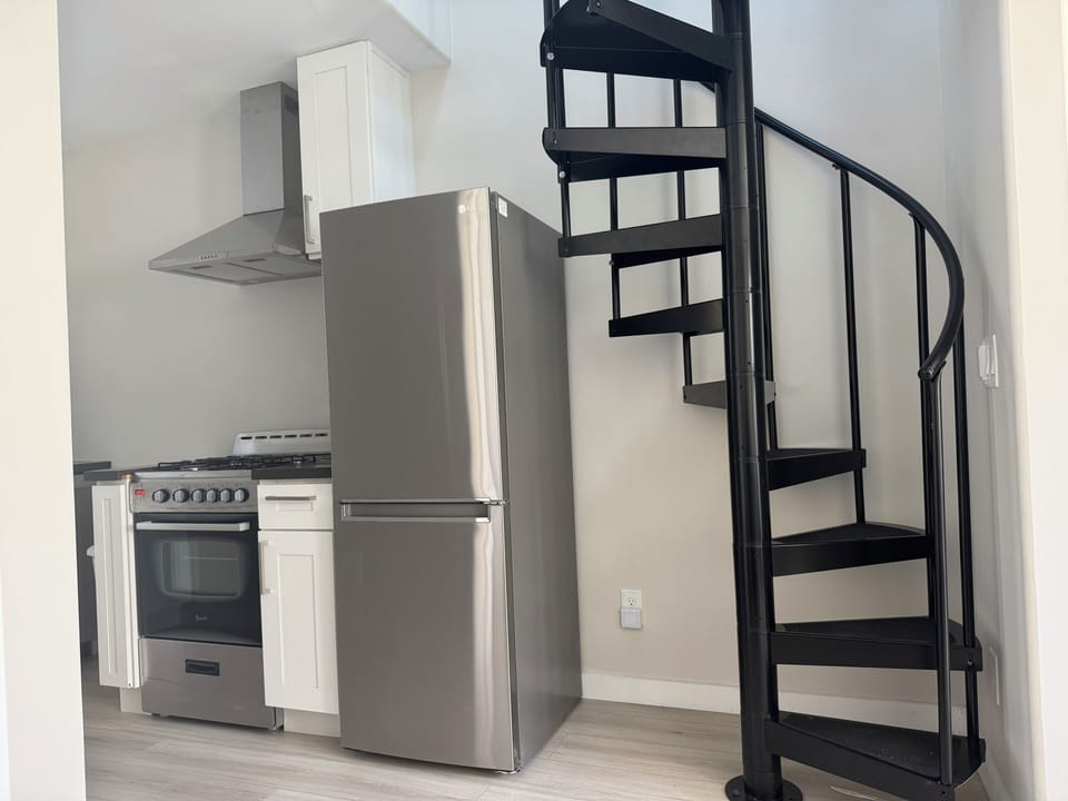 Spiral stairs lead to the sleeping loft.