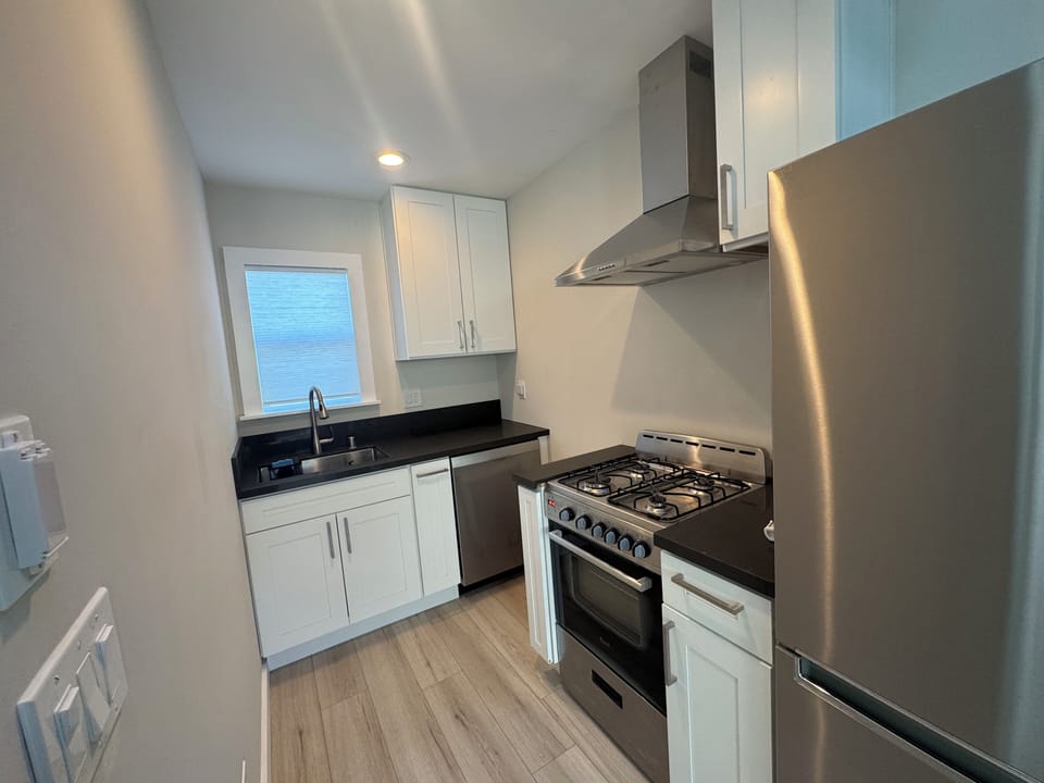 The kitchen is small but mighty, with gas stove, dishwasher, disposal, fridge.