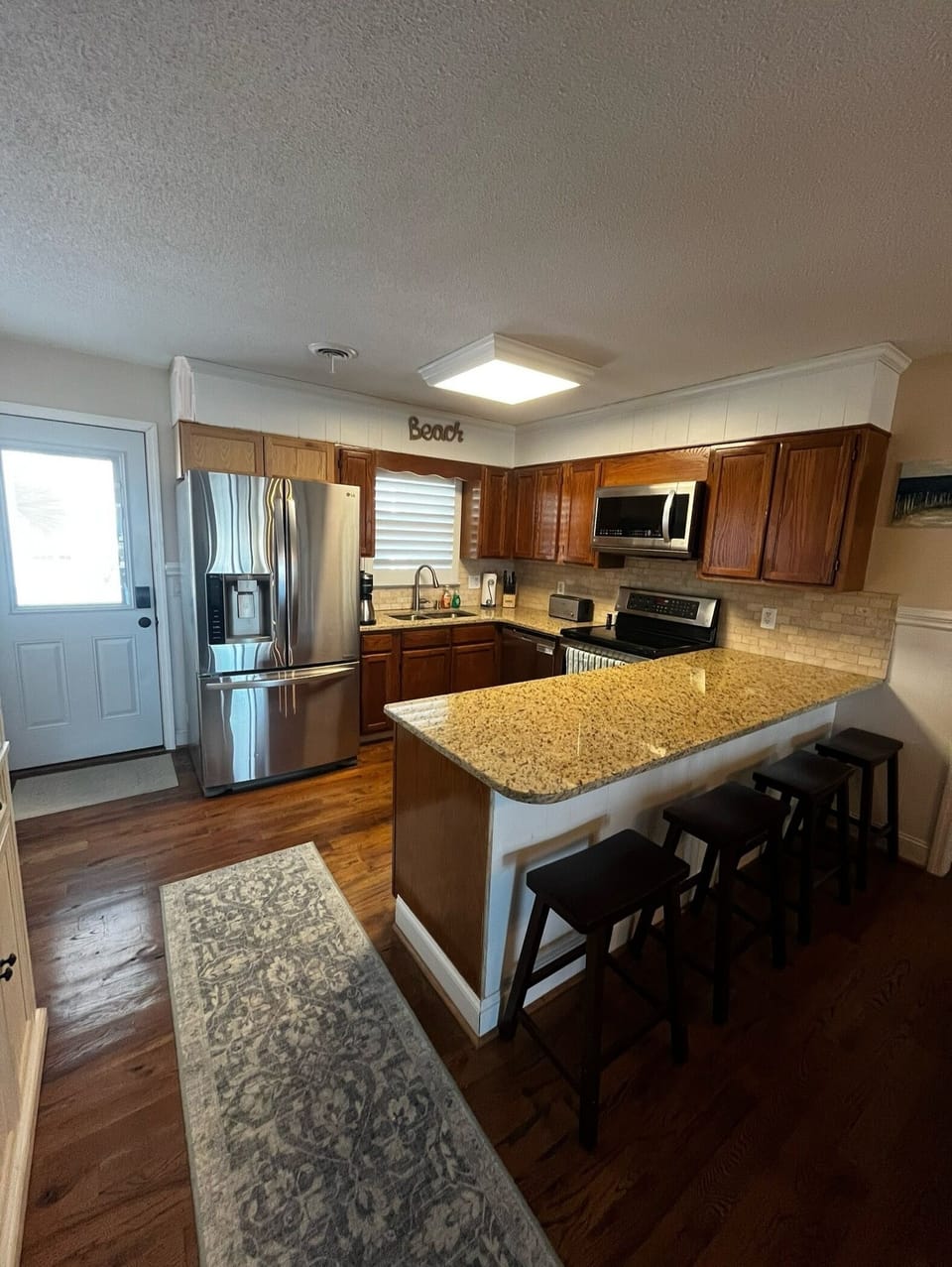 Fully stocked kitchen with pantry cabinet and pantry closet with shelves.