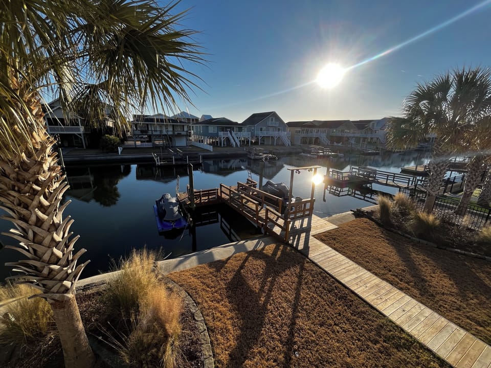 Backyard and canal. Large boat dock with seating