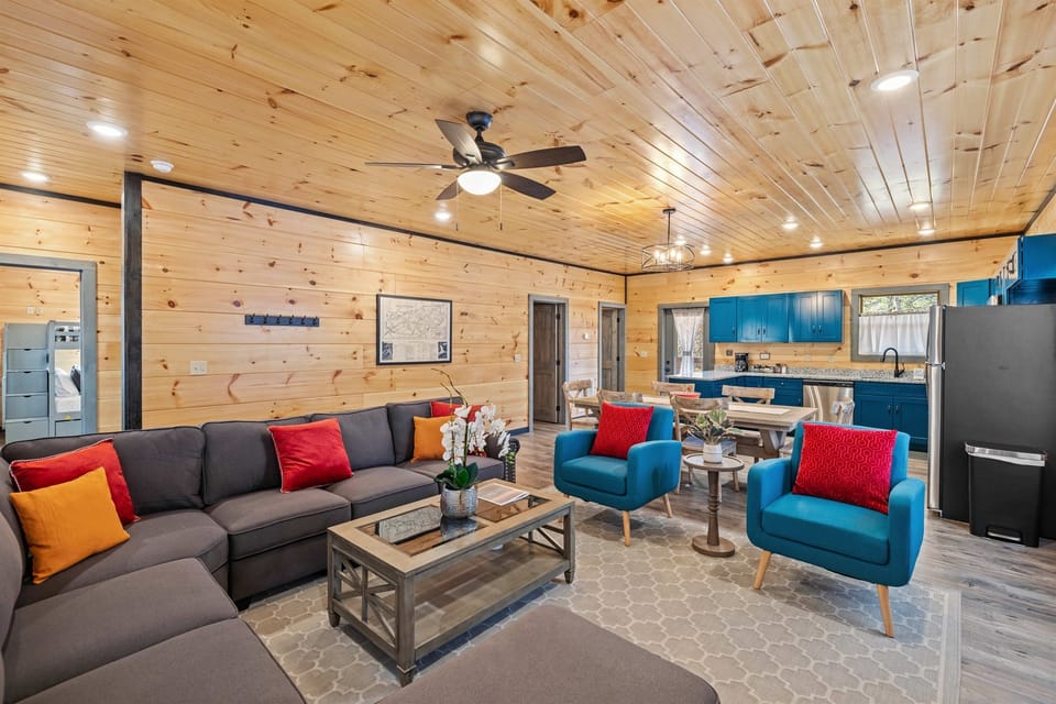 Open concept living room with large TV and electric fireplace.