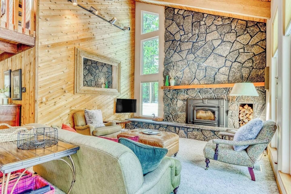 Warm living room with stone fireplace and comfortable seating—perfect for relaxing and entertaining.
