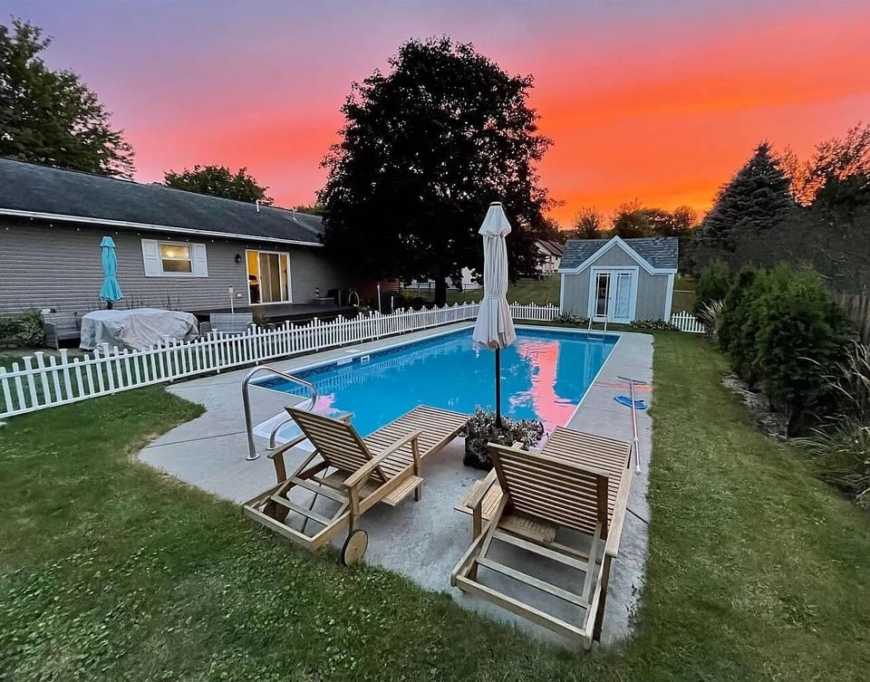 Dive into summer fun in the heated pool surrounded by lush greenery.