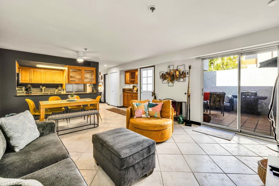 Open-concept living, dining, and kitchen with warm modern finishes