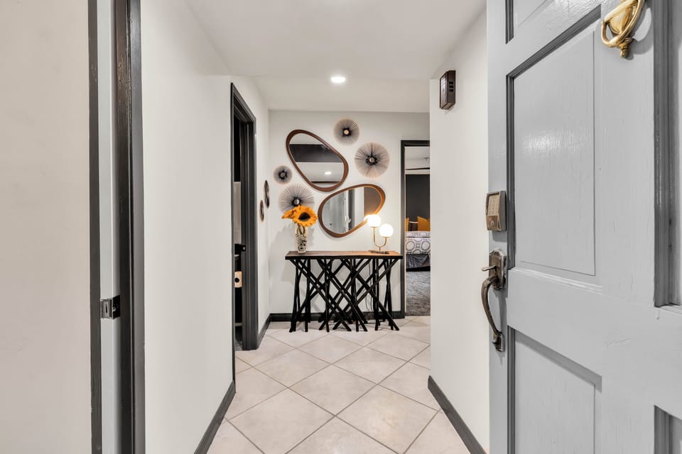 Inviting entry hallway with designer accents and bedroom access