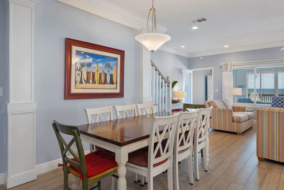 Gather around your spacious dining table for memorable meals, with coastal artwork setting a relaxed beach vibe throughout your open-concept retreat.