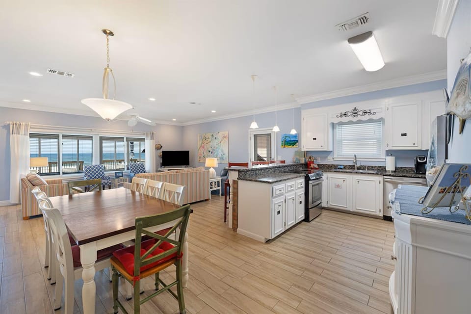 Your spacious open-concept kitchen flows seamlessly into the dining and living areas, where ocean views from your windows create the perfect backdrop for memorable meals.