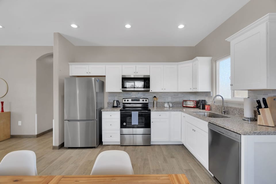 Clean, bright full kitchen for making meals at home.