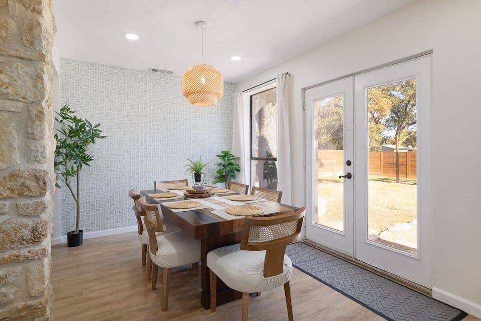 Sunlit mornings and shared dinners come naturally in this inviting dining space, with backyard views just steps away. A warm, welcoming setting designed for lingering meals and easy conversation.