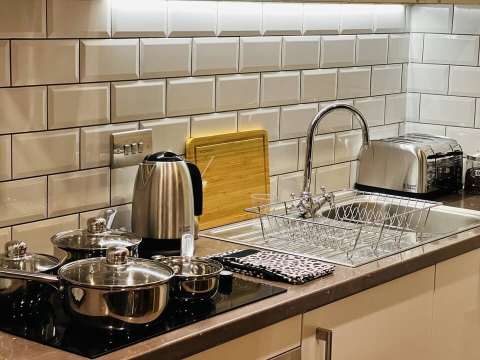 Fully stocked kitchen equipped with essential appliances, cookware, and utensils, ensuring everything you need for convenient meal preparation