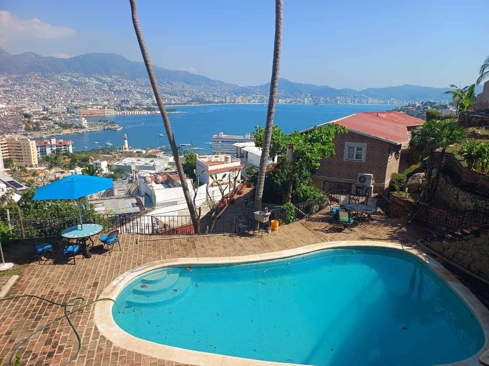 Spacious backyard with a pool and full view of the bay.