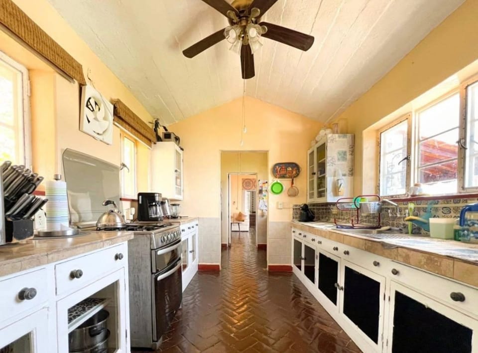 Equiped kitchen with oven, fridge, kitchen tools.