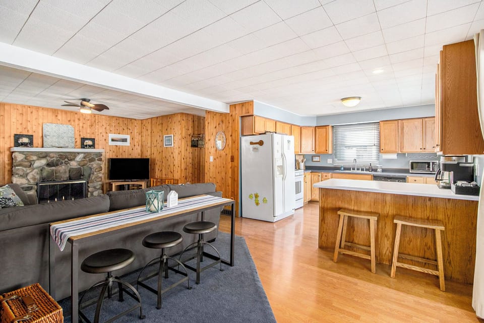 Open living and kitchen with a three-stool dining bar