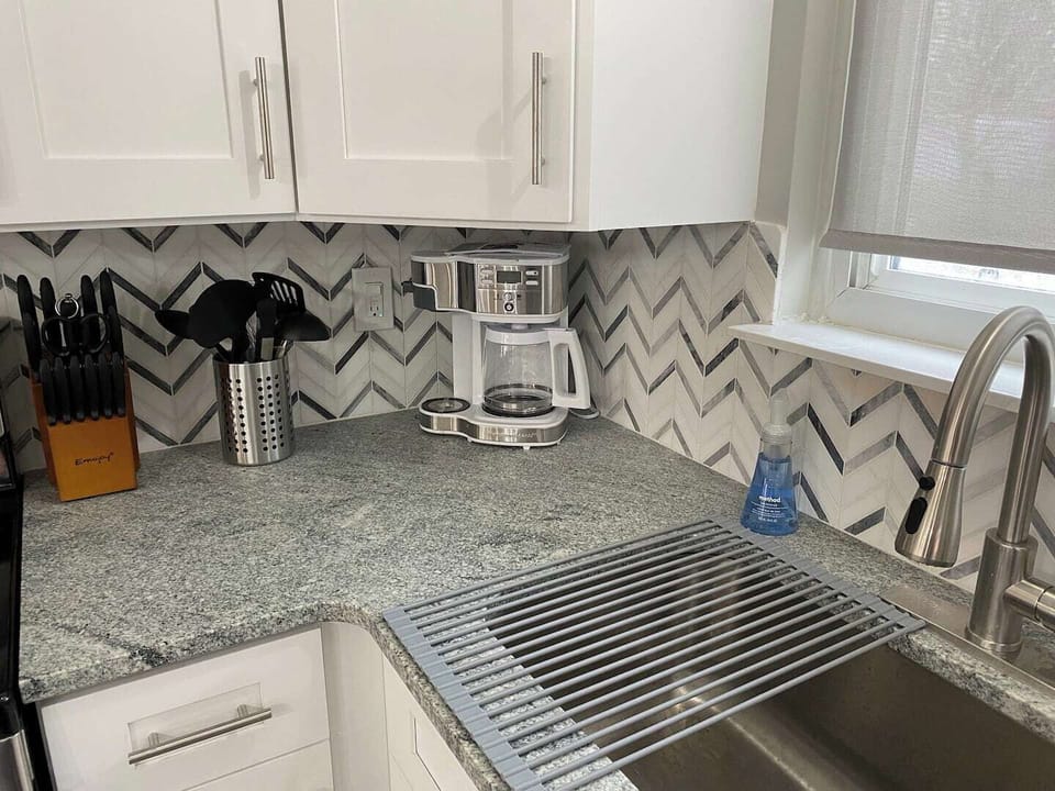 All the utensils you need to prep and cook your favorite meals, in addition to a coffee maker that allows you to brew one cup at a time or a whole pot!