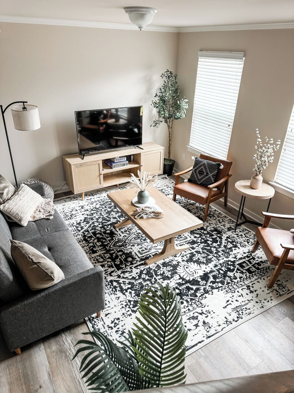 Living Room w/ Couch Bed, 55" Roku Smart TV, and 2 Vegan Leather Chairs