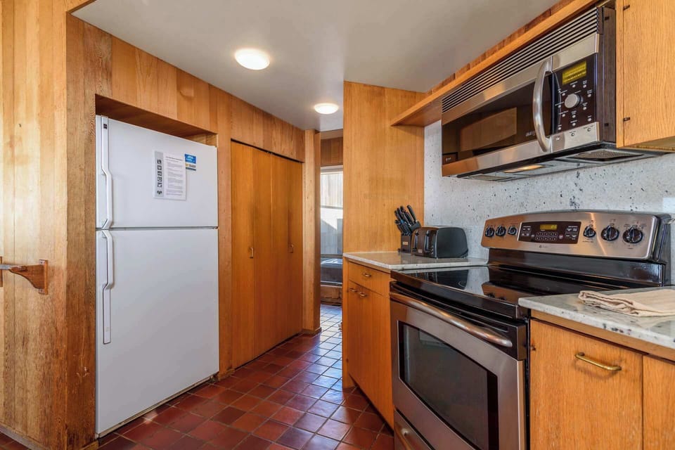 The breezy kitchen offers ample space & every home comfort