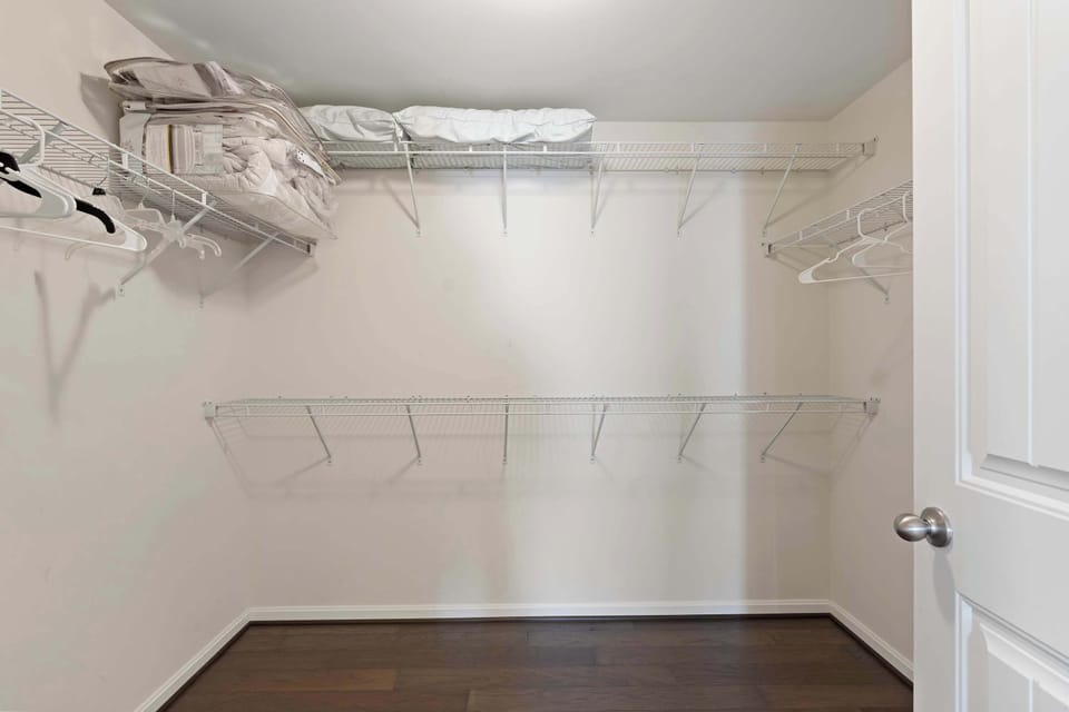 The king ensuite features a double vanity, glass shower, & walk-in closet
