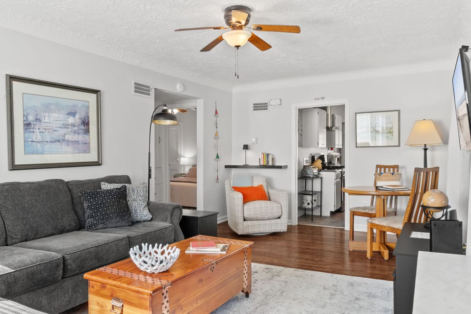 Family room -hardwood floor with large sectional, swivel chair, & small table