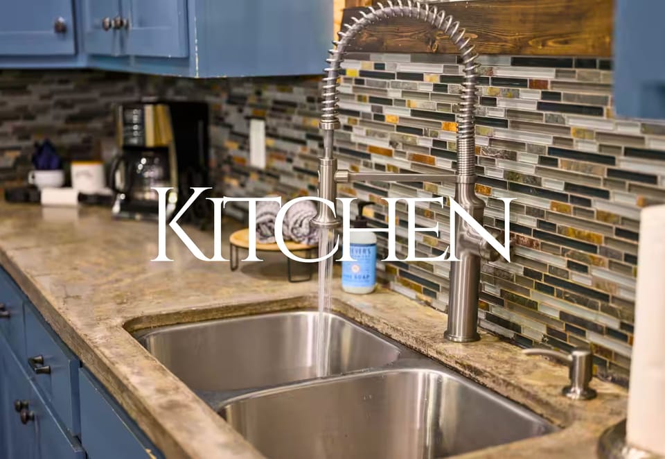 A sleek and contemporary sink area adds a touch of elegance to the kitchen, complete with a shimmering backsplash that catches the light.