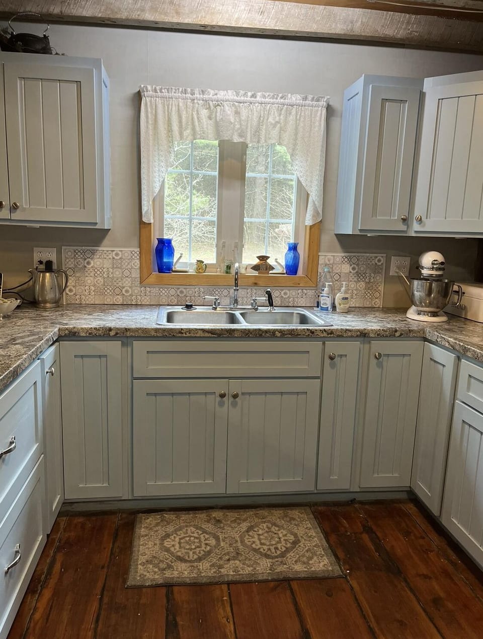 Full kitchen with Amish built cupboards, cooking, serving and dining dishes. 