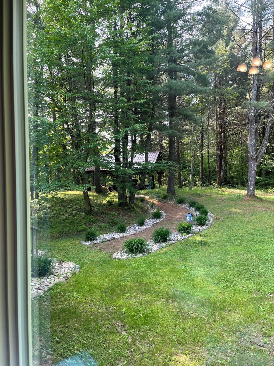 Side yard path to the pavilion. F.our picnic table with benches