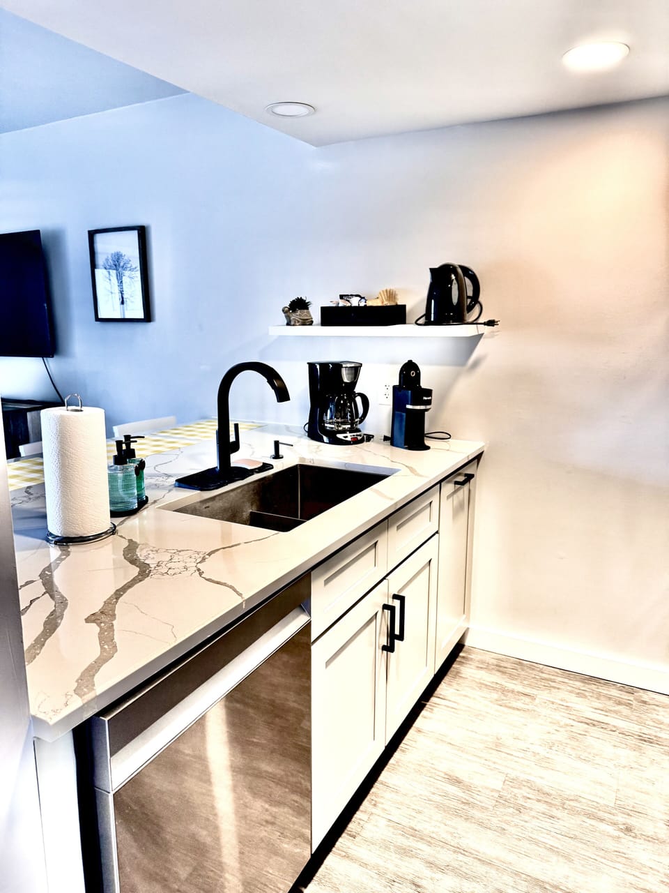 Sleek modern kitchen with marble countertops and coffee station ready for your morning brew.