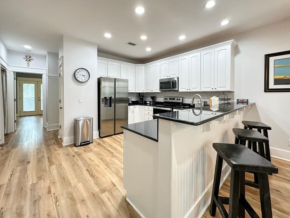 The kitchen houses stainless steel appliances and a pantry closet
