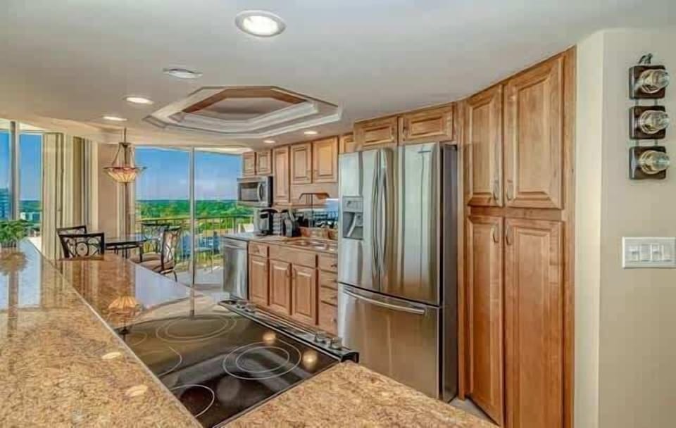 The beautiful kitchen has granite countertops, stainless steel appliances and wood cabinets. Fix a meal overlooking the ocean or watching a sunset!