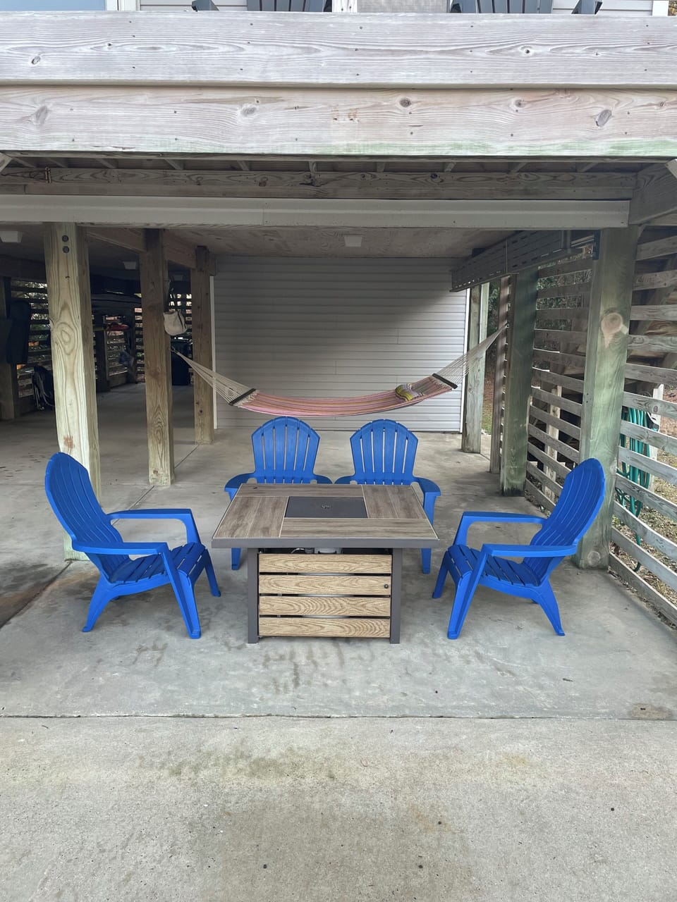 Sitting space under house with fire pit