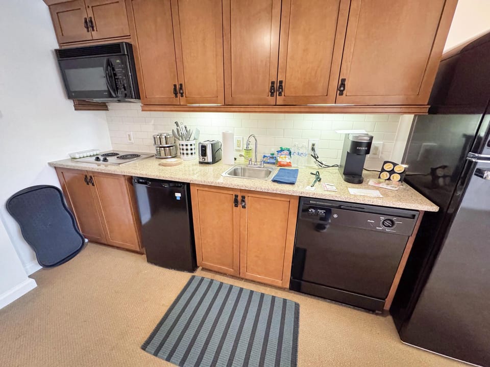 Kitchen has all new items including dishware, cookware, utensils, glassware and a near full size fridge
