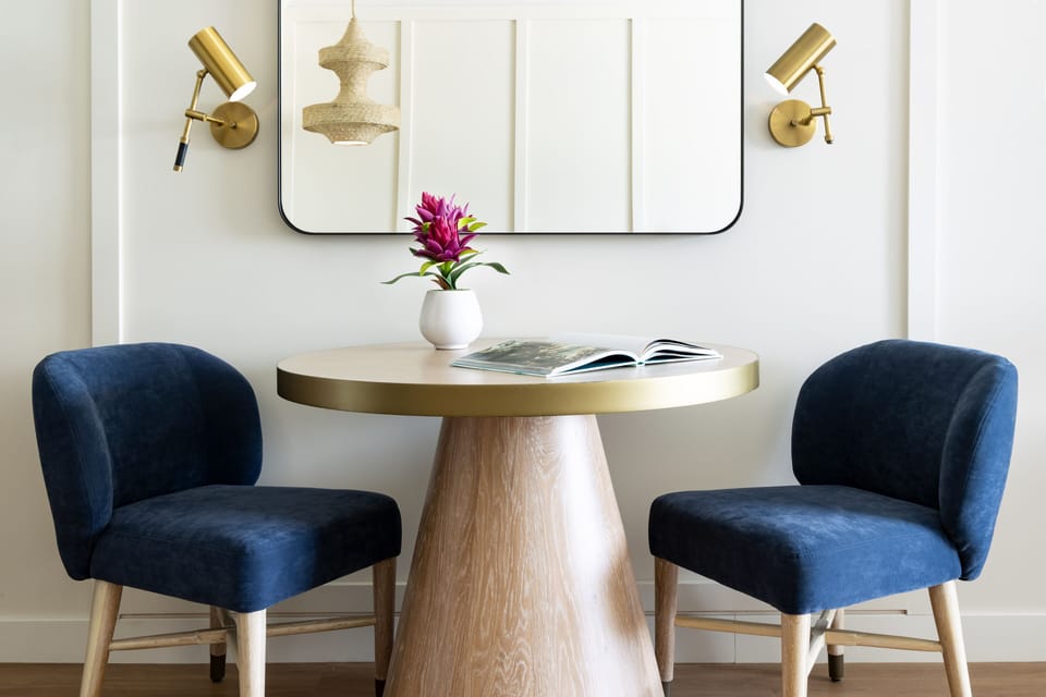 Sip coffee together at a cozy table under warm sconces.