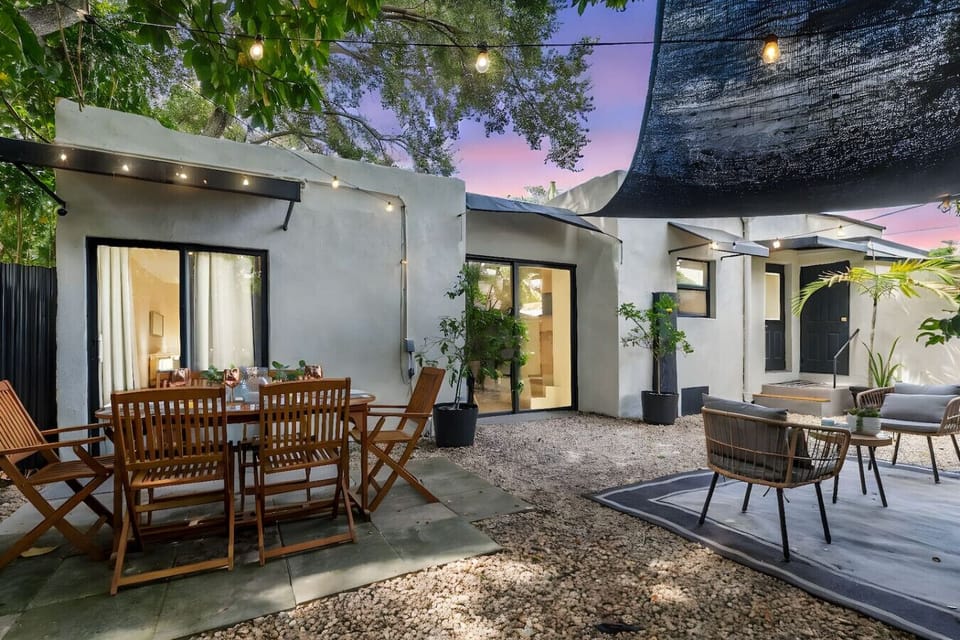 Private Miami patio with dining & lounge area — perfect for evening BBQs under the lights.