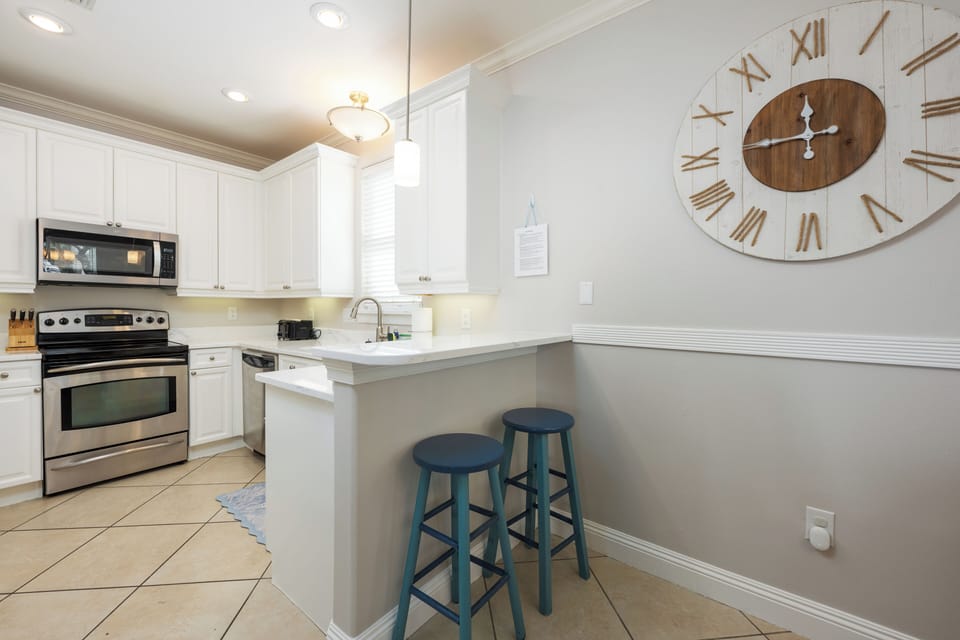 bar seats and onlooking the kitchen.