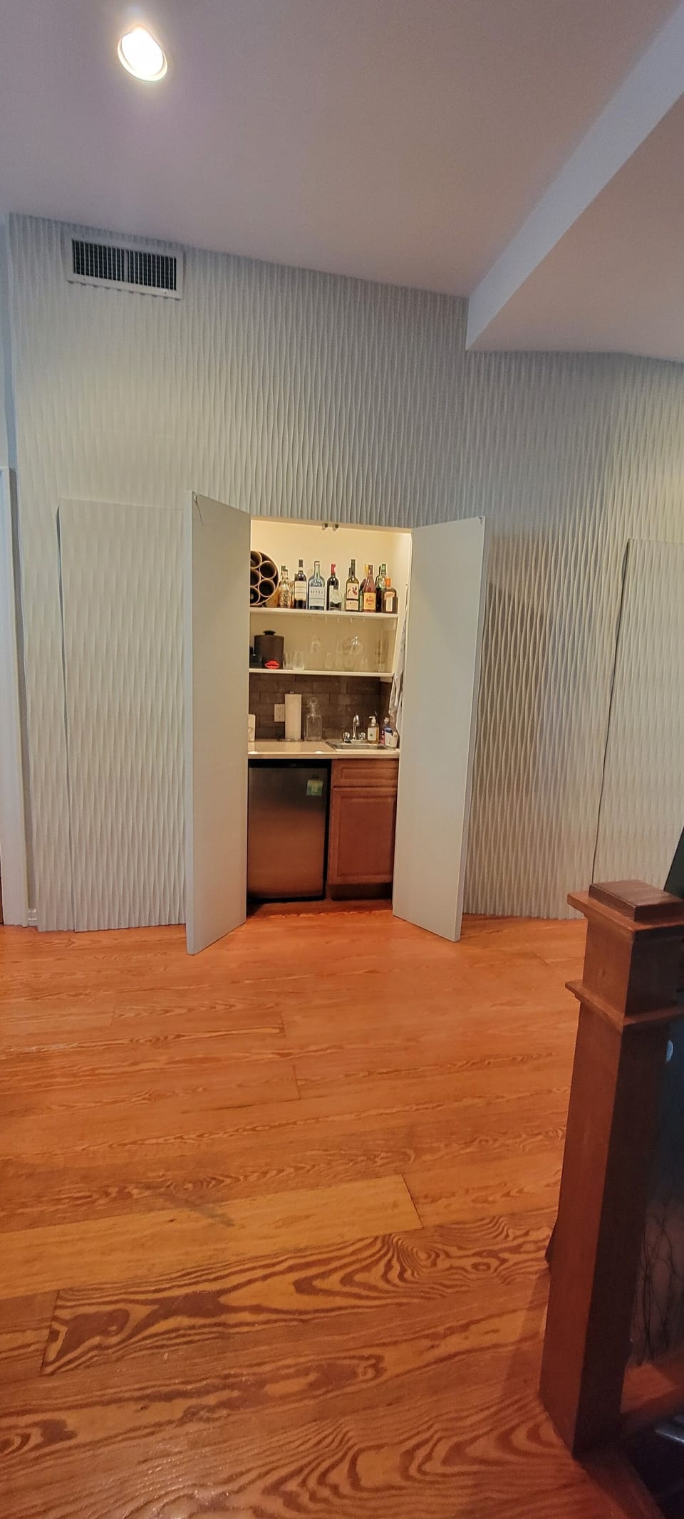 The minibar hidden by the feature wall off the living room. Ice without stairs!