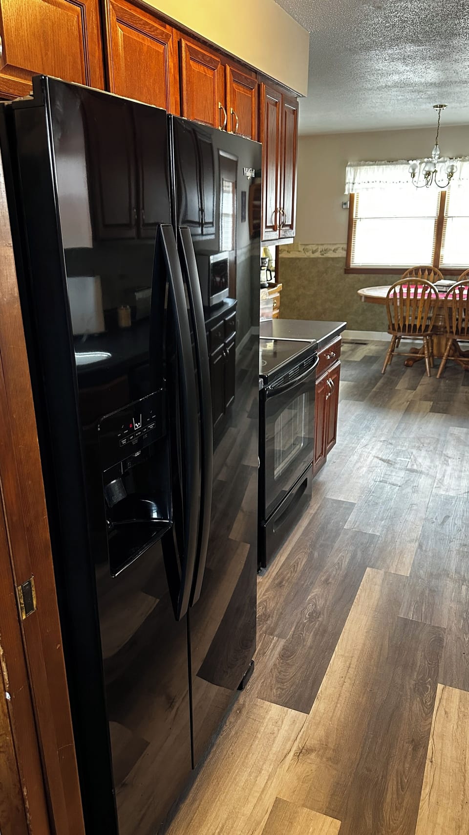 Electric stove with all cook ware. Large refrigerator water and ice in the door
