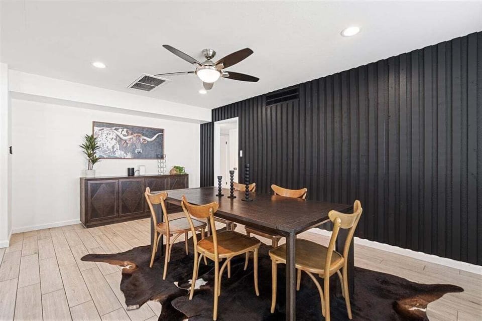 Dining area next to the kitchen with seating for 5 guests and access to the backyard.