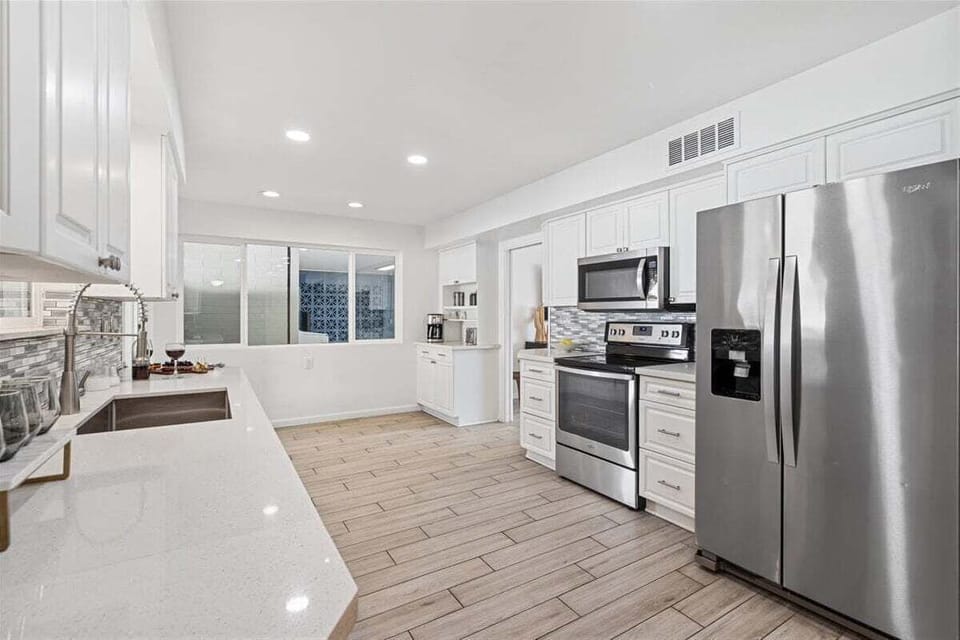 Fully equipped kitchen with stainless steal appliances and access to the backyard.
