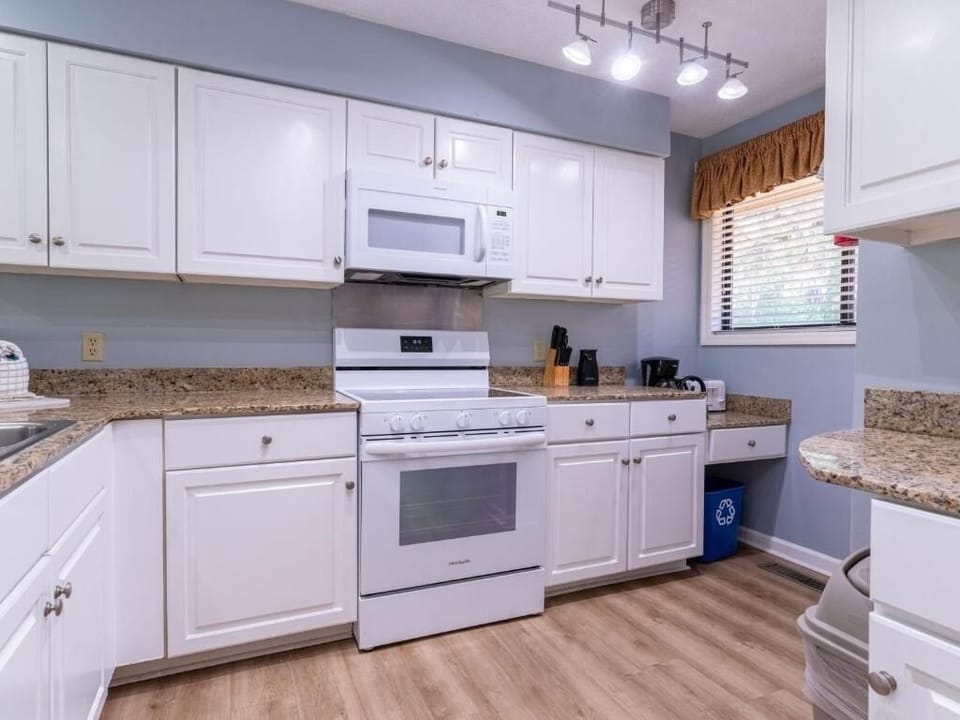 Prep meals effortlessly with full-size range, microwave, and storage.