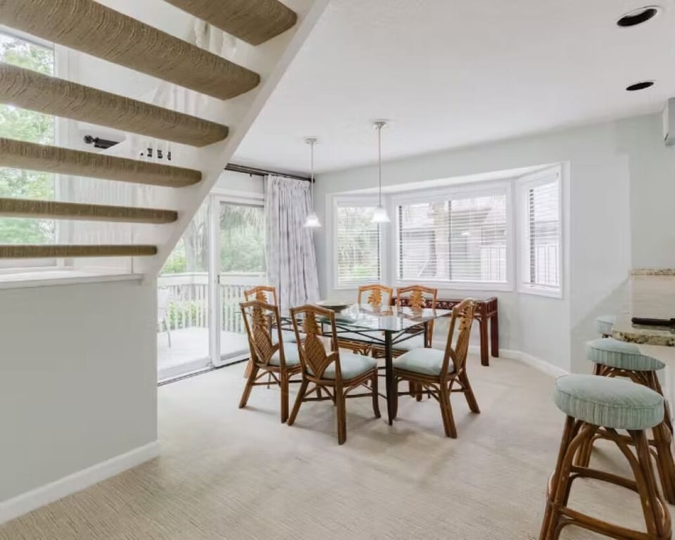 Gather for easy meals beside bright windows and patio doors.