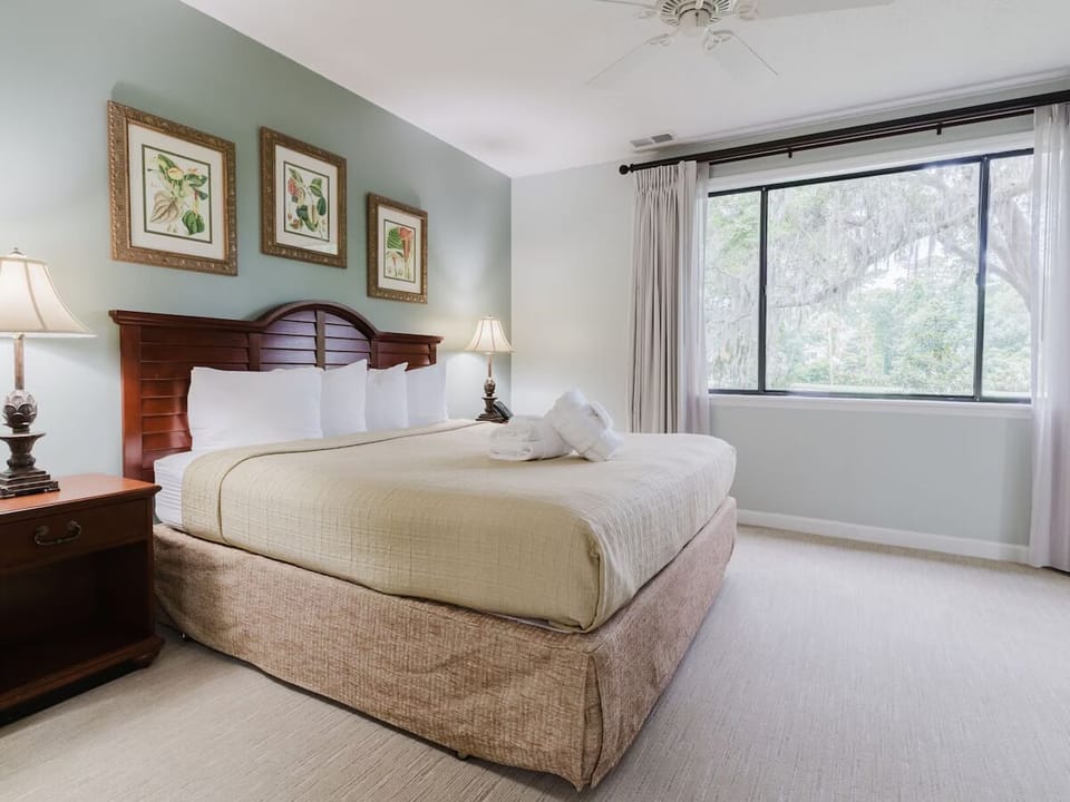 Unwind in a serene king bedroom with soothing garden views.