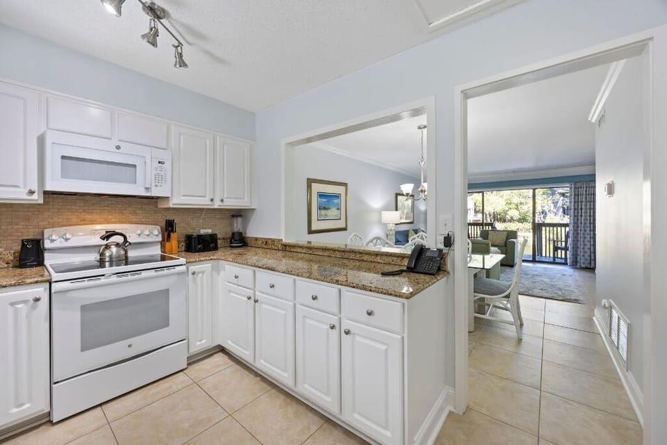 Cook with ease in the crisp kitchen with ample counters.