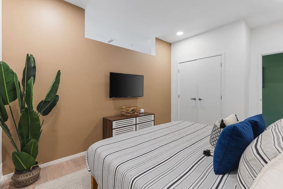 Comfortable bedroom with a king-size bed, TV, and spacious closet.