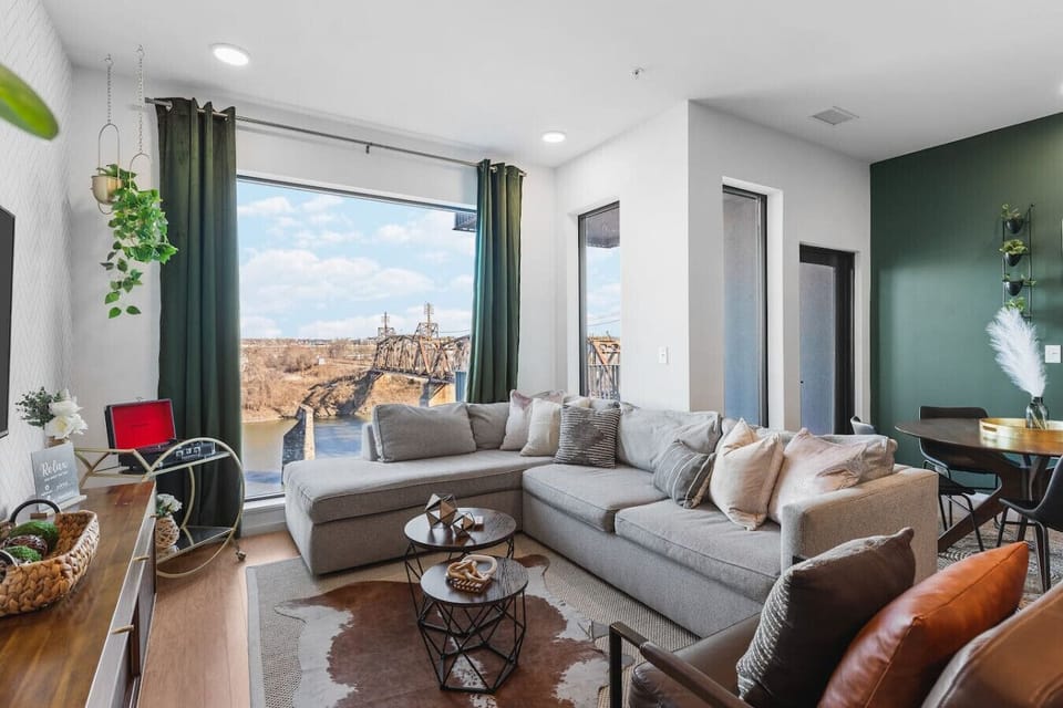 Spacious living room with queen pull-out couch, stunning riverfront views, and a Smart TV for your entertainment. Enjoy your morning coffee on our private patio that overlooks Cumberland river.