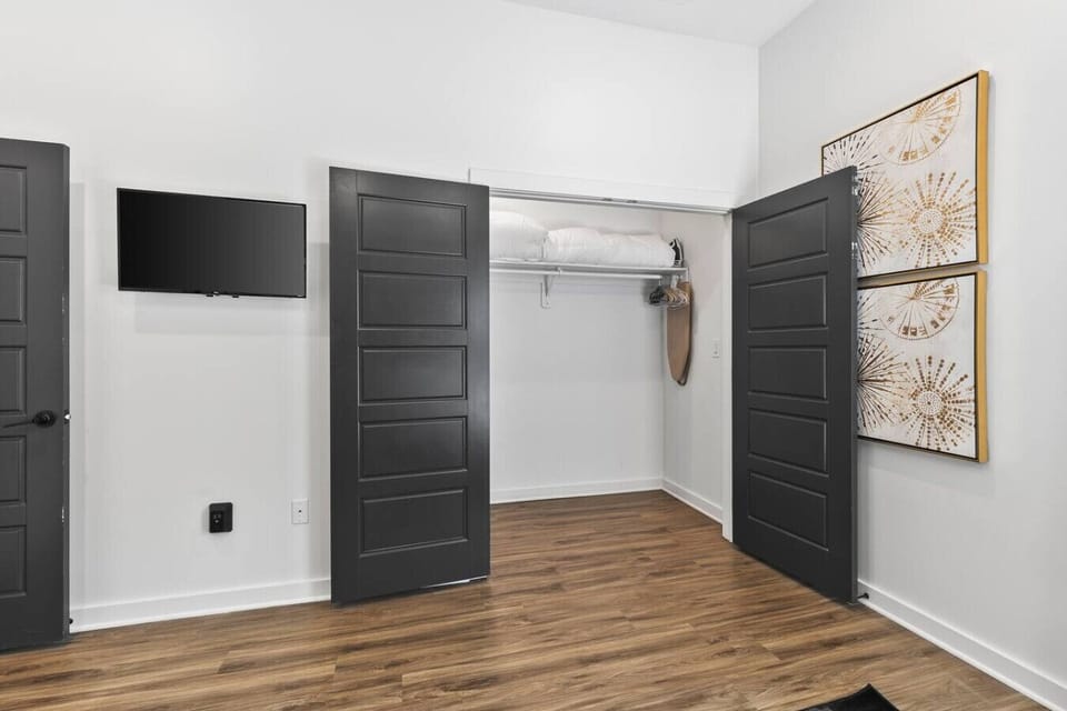 Bedroom with one queen over queen bunk bed, and another full over full bunk bed. Room darkening shades, closet to store your items in, Smart TV and attached full size bathroom.