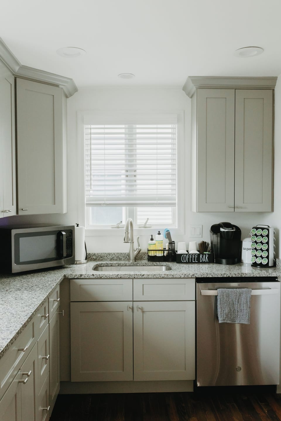 Bright, sunny sink area with microwave and coffee station