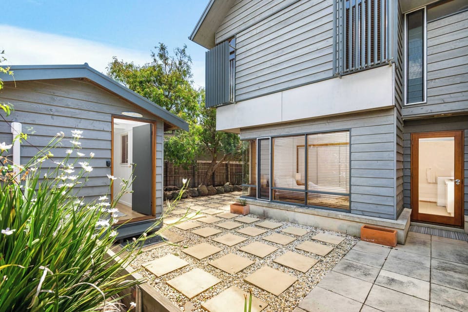 Tidy backyard with outdoor studio & shower.